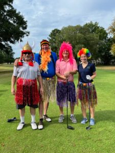 team members standing in costume at a golfing event